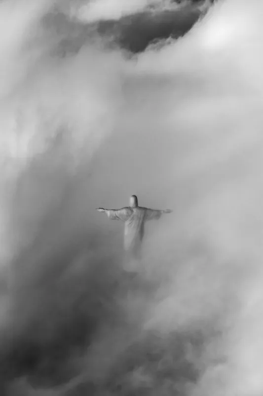 Cristo Redentor entre as nuvens, em preto e branco.